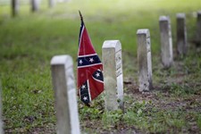  - 
              A confederate flag is seen at a tombstone on the cemetery at  Beauvoir House, Jefferson Davis' historic home, in Biloxi, Miss., Thursday, Aug. 16, 2012.  Commemorating the 150th anniver