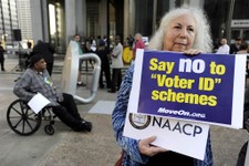  - 
              Gloria Gilman holds a sign during the NAACP voter ID rally to demonstrate the opposition of Pennsylvania's new voter identification law, Thursday, Sept. 13, 2012, in Philadelphia. Penns