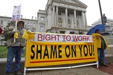  - 
              FILE - In this Nov. 22, 2011 file photo, Joe Lubbers, left, and Rick McKee display a sign in front of the Statehouse before start of Organization Day in Indianapolis. Union members rall