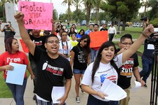  - 
              FILE - In this Aug. 16, 2012 file photo, Joshua Montano, left, and Deborah Robles protest in front of the Capitol the day after Arizona Gov. Jan Brewer, in an executive order reaffirmin
