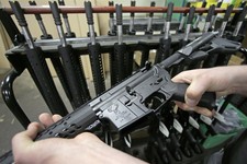  - 
              Veetek Witkowski holds a newly assembled AR-15 rifle at the Stag Arms company in New Britain,  Conn, Wednesday, April 10, 2013. A Connecticut gun-maker announced on Wednesday it intends