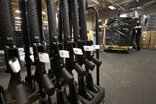  - 
              A rack of AR-15 rifles stand to be individually packaged as workers move a pallet of rifles for shipment at the Stag Arms company in New Britain, Conn., Wednesday, April 10, 2013. A Con