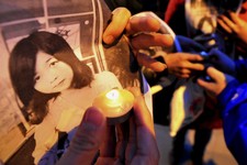  - 
              In this Wednesday, April 17, 2013 photo, Chinese hold pictures of Lu Lingzi, a Boston University graduate student from China who was killed Monday in the Boston Marathon explosions, as 