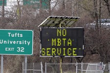  - 
              A sign along I-93 in Medford, Mass. announces no MBTA service Friday, April 19, 2013. Two suspects in the Boston Marathon bombing killed an MIT police officer, injured a transit officer