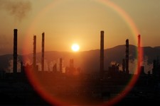  - 
              FILE - In this Tuesday, May 2, 2006, file photo, the sun sets over a oil refinery in Tarragona, Spain. In the 2000s, large investors in so-called clean technology wanted to finance comp