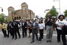  - 
              Alabama Southern Christian Leadership Conference Director Bishop Calvin Woods, center with bullhorn, leads thousands of young students on a march through downtown Birmingham, Ala., Thur