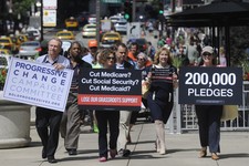  - 
              FILE - In this July 15, 2011, file photo, members of  Progressive Change Campaign Committee upset over potential cuts to Medicare, Medicaid and Social Security walk to President Barack 