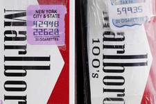  - 
              In this Tuesday, April 30, 2013 photo, two packs of Marlboro cigarettes, the one on the left with a New York City and state tax stamp, and on the right a Virginia tax stamp, are display