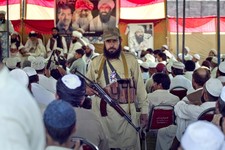  - 
              In this Thursday, May 2, 2013, an armed supporter of a pro-Taliban religious group Jamiat-e-Ulema Islam (JUI-F), stands guard as others listen the speech of their leader Maulana Shujaul