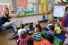  - 
              FILE - In this March 29, 2011, file photo four and five-year-old preschool students listen to their teacher, Angie Clark, read at a Des Moines Iowa elementary school. Within the last ye