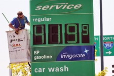  - 
              FILE - In this May 15, 2013 file photo, a service person works on sign at BP station at 35E and County Road E in Vadnais Heights, Minn. The average U.S. price of a gallon of gasoline ha