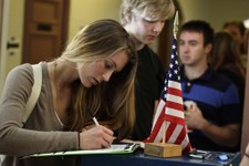  - 
              FILE - In this Nov. 6, 2012 file photo, Madeline Nicole Kreyger, from Santa Barbara, Calif., casts her vote at a polling station on the campus of the University of Colorado in Boulder, 