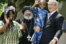  - 
              FILE – In is May 30, 2007, file photo President Bush, right, hoists 4-year-old Baron Mosima Loyiso Tantoh, son of Manyongo Mosima "Kuene" Tantoh of South Africa, left, who is HIV-positi