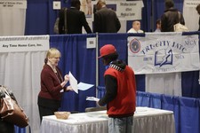  - 
              FILE - In this Thursday, April 11, 2013 file photo, Kathie Maiello of Any-Time Home Care, left, talks with Jashod Chaney, of Albany, at the Dr. King Career Fair at the Empire State Plaz