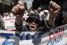  - 
              An elderly woman chants anti-austerity slogans during a protest by hundreds of pensioners in central Athens, Thursday, June 6, 2013. Elderly Greeks have faced successive pension cuts si
