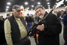  - 
              FILE - In a Saturday, Jan. 5, 2013 file photo, gun owners discuss a potential sale of an AR-15, during the 2013 Rocky Mountain Gun Show at the South Towne Expo Center in Sandy, Utah. Ne
