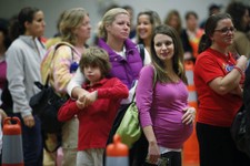  - 
              FILE - In this Thursday, Oct. 29, 2009 file photo, Nicole Andreacchio, second right, who is seven months pregnant waits in line to receive the swine flu vaccine from the Montgomery Coun