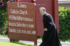  - 
              In this Sunday, June 16, 2013 photo, a clergyman walks up a small rise near the entrance of St. James Catholic Church in Ogden, Utah after police say Charles Richard Jennings Jr. walked