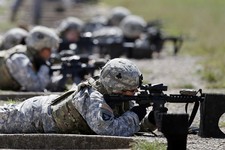  - 
              FILE - In this Sept. 18, 2012 file photo, female soldiers from 1st Brigade Combat Team, 101st Airborne Division train on a firing range while testing new body armor in Fort Campbell, Ky