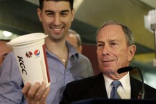  - 
              FILE - In this March 12, 2013 file photo, New York City Mayor Michael Bloomberg looks at a 64-ounce cup, as Lucky's Cafe owner Greg Anagnostopoulos, left, stands behind him, during a ne