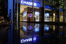  - 
              FILE - In this Thursday, May 10, 2012, file photo, automobiles pass a JP Morgan Chase building in New York.  The financial crisis hammered banks and choked off loans to businesses and c