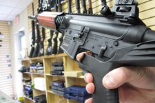 - 
              In this Feb. 1, 2013 photo, an employee of North Raleigh Guns demonstrates how a "bump" stock works at the Raleigh, N.C., shop. The accessory devices, which legally allow a semiautomati
