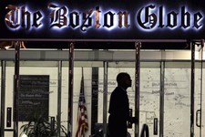  - 
              FILE - In this July 20, 2009 file photo, a security guard walks past the entrance of The Boston Globe building in the Dorchester neighborhood of Boston. The New York Times Company, whic