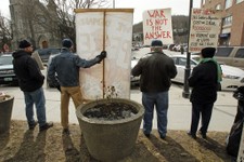  - 
              In this March 15, 2013 photo, protesters hold signs in front of the federal building in Montpelier, Vt. More than a decade after anti-war protesters started a weekly vigil in front of t