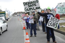  - 
              Brady Eggleston of Newtown, a supporter of gun control stands in front of supporters for gun rights outside the National Shooting Sports Foundation headquarters  in Newtown, Conn., Thur