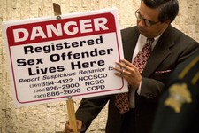  - 
              File - In This May 18, 2001 file photo, Nueces County Texas District Attorney Carlos Valdez looks at one of the signs that District Judge Manuel Banales ordered 21 registered sex offend