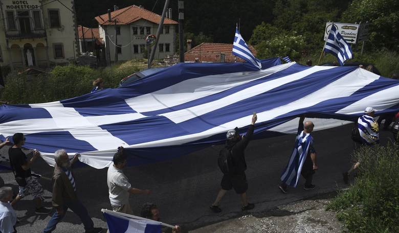 Dumb Bigot Rips Down Flag in an Act of Anti-Semitism Before Realizing it's ACTUALLY a Greek Flag (WATCH)