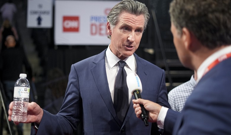 Watch Adam Carolla Ruthlessly Roast Gavin Newsom for His Covid Tyranny During Debate Interview 