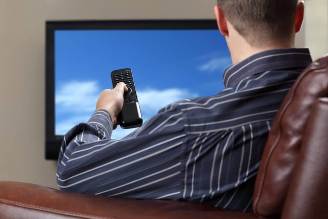 Guy watching cable television