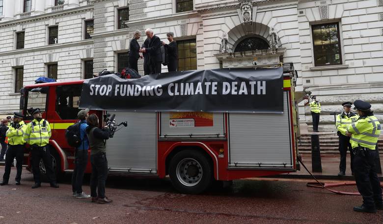 London Climate Protesters Hilariously Lose Control of Hose Spewing 'Fake Blood'