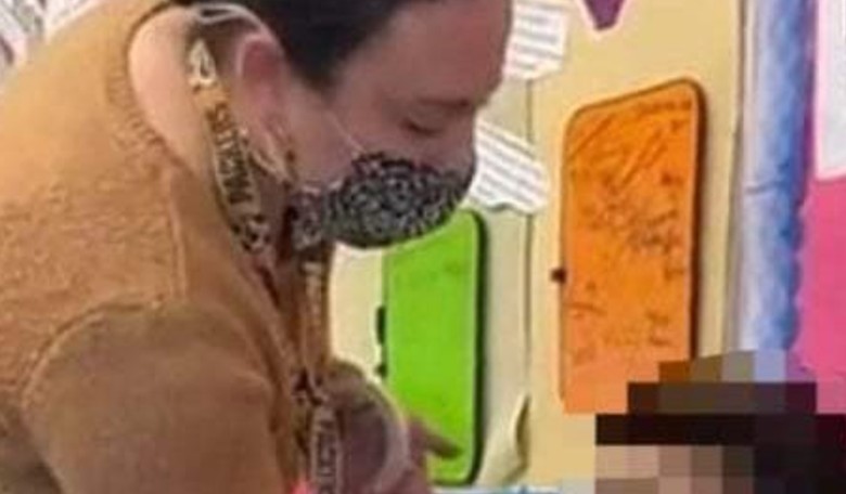 Teacher Caught Taping a Mask to the Face of a Young Student