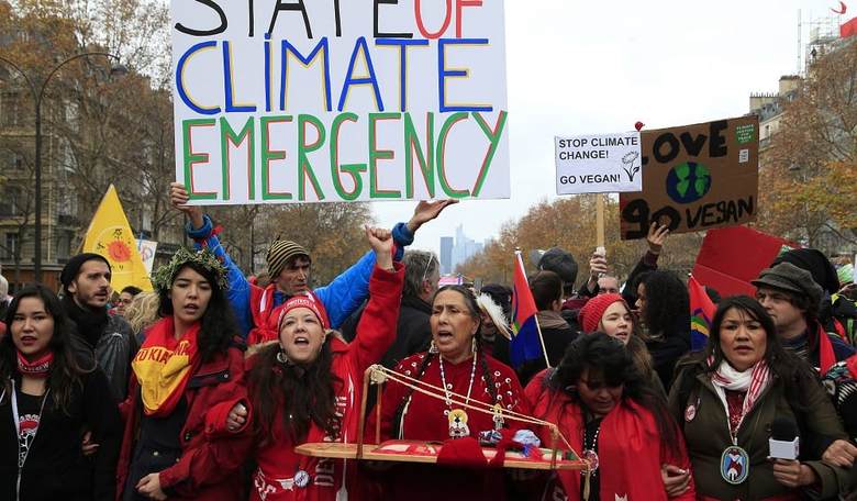 WATCH: Paris Climate Accords Negotiator Glues Herself to the Street Outside Oil Company Building