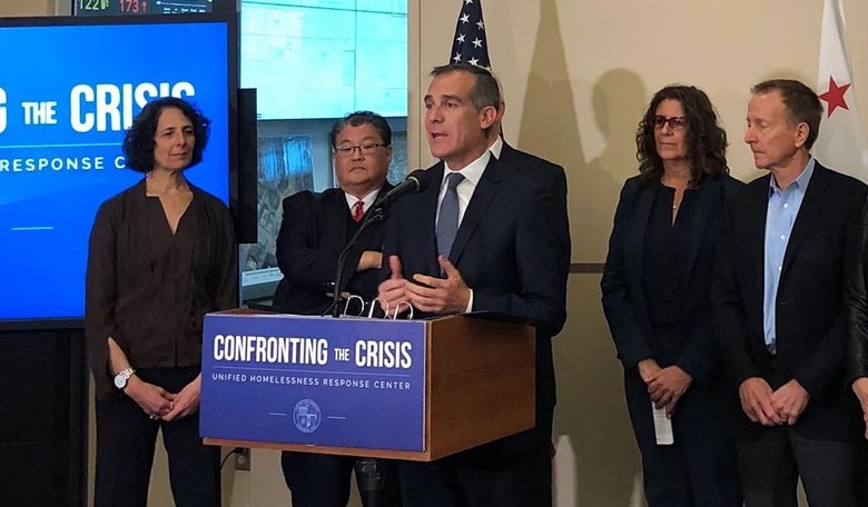 LA Mayor Garcetti Rides onto Skid Row on Wheeled Trash Cans Screaming, "Merry Christmas!"