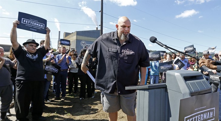 John Fetterman, center, the mayor of Braddock, Pa., comes forward to announce his candidacy for the U.S. Senate, Monday, Sept. 14, 2015, in Braddock. (AP Photo/Keith Srakocic)