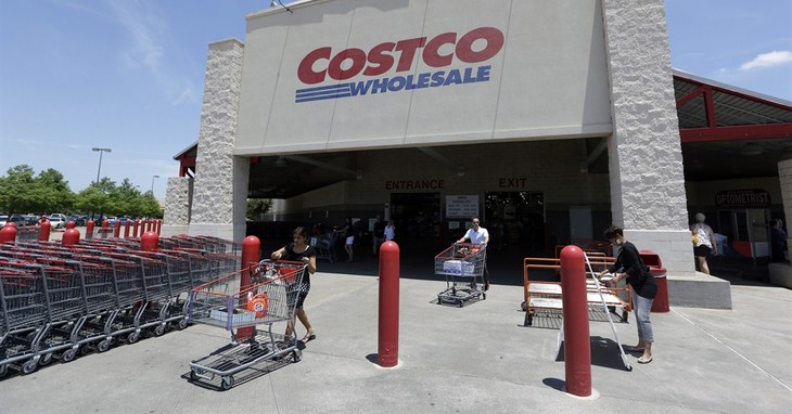 In this June 4, 2014 photo, shoppers push carts out of a Costco in Plano, Texas. Costco on Monday, March 2, 2015 said it struck a deal for Citi to be the exclusive issuer of its co-bran