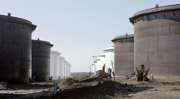 This March 13, 2012 photo shows older and newly constructed 250,000 barrel capacity oil storage tanks at the SemCrude tank farm north of Cushing, Okla. For the past seven weeks, the Uni