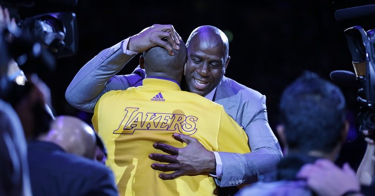 Los Angeles Lakers forward Kobe Bryant, left, hugs Magic Johnson during a ceremony before Bryant's last NBA basketball game, against the Utah Jazz, Wednesday, April 13, 2016, in Los Ang