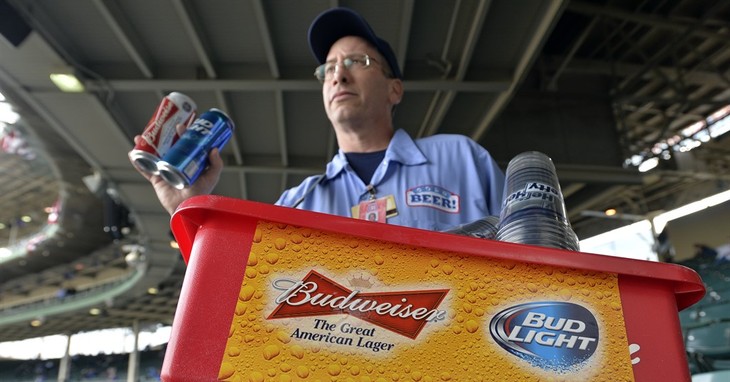 FILE - In this Tuesday, Oct. 13, 2015, file photo, a beer vender holds up Budweiser and Bud Light at Wrigley Field before Game 4 in baseball's National League Division Series between th