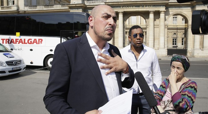 Marwan Muhammad, head of the Collective Against the Islamophobia in France, answers reporters outside the Conseil d'Etat, France's top administrative court, in Paris, Friday, Aug. 26, 2