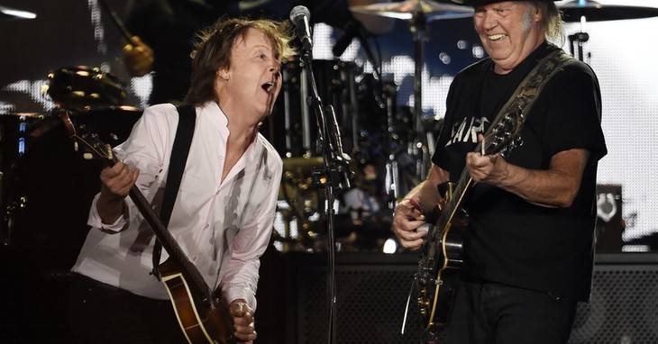 Paul McCartney, left, is joined by Neil Young during his performance on day 2 of the 2016 Desert Trip music festival at Empire Polo Field on Saturday, Oct. 8, 2016, in Indio, Calif. (Ph