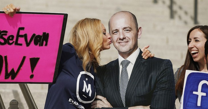 In this Oct. 13, 2016, file photo, Brynnley Pyne pretends to kiss a cardboard cutout of Evan McMullin as McMullin supporters rally at the Utah State Capitol in Salt Lake City. Two month