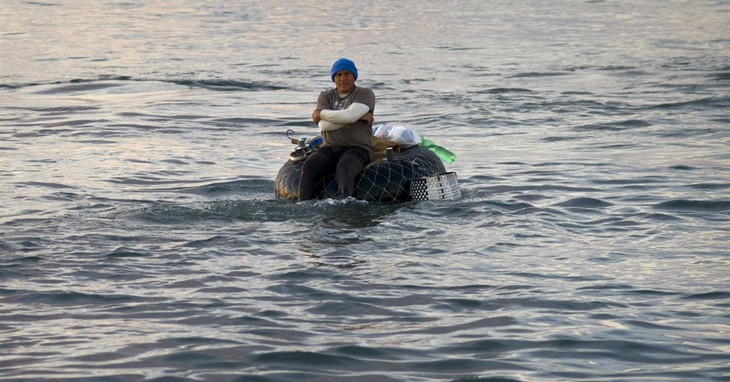 In this Nov. 11, 2016 photo, a fisherman floats on his raft made out of a tire inner tube, off Chivo beach in Havana, Cuba. Many Cubans have taken to riding out on inner tubes to catch