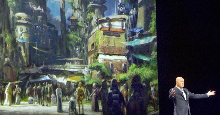 FILE - In this Saturday, Aug. 15, 2015, file photo, Bob Chapek, chairman of Walt Disney Parks and Resorts, speaks in front of concept art of the newly announced Star Wars Land at the D2