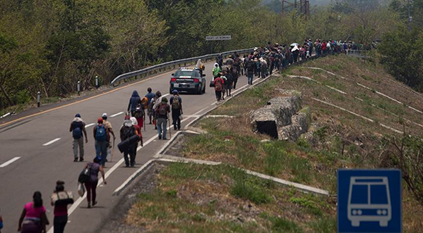 Carrying Biden Signs, Massive Migrant Caravan Pushes Toward U.S.